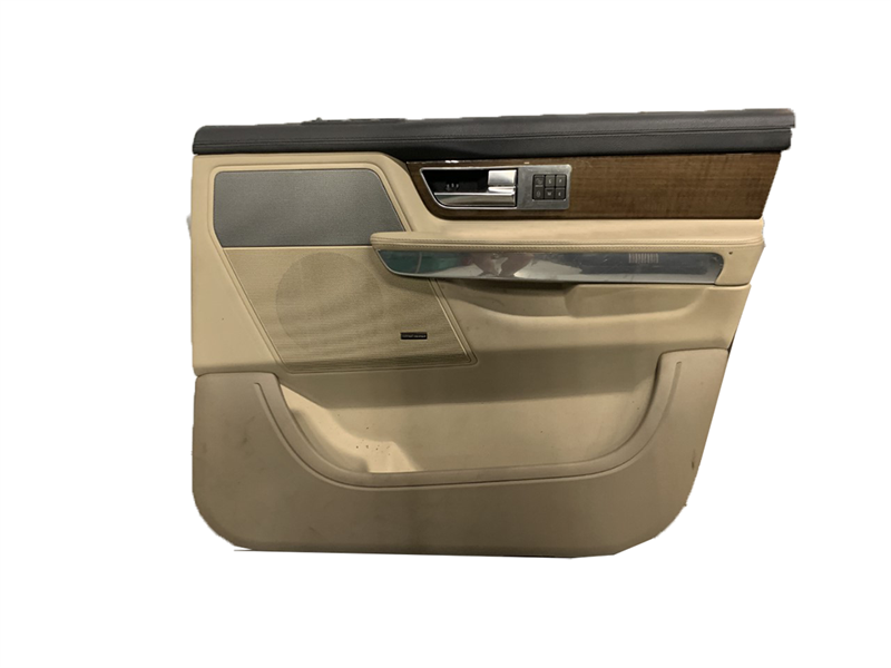 Beige and black Range Rover door panel featuring wood and chrome accents door trim