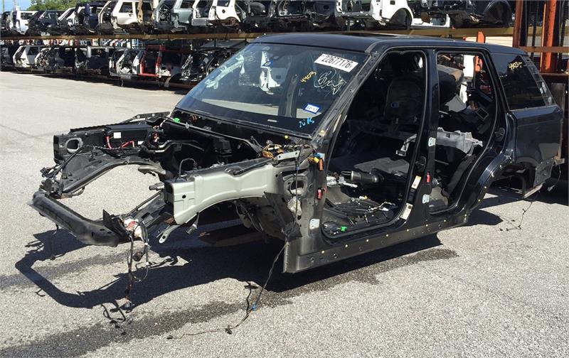 Range Rover Body Shell frame without doors or engine in an outdoor parts yard