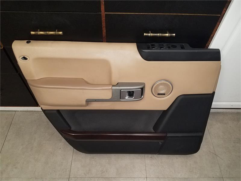 Range Rover beige and black interior door panel with control buttons and handle