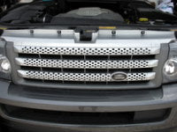 Silver Range Rover front grille DHB500390WWQ installed on vehicle with headlights visible