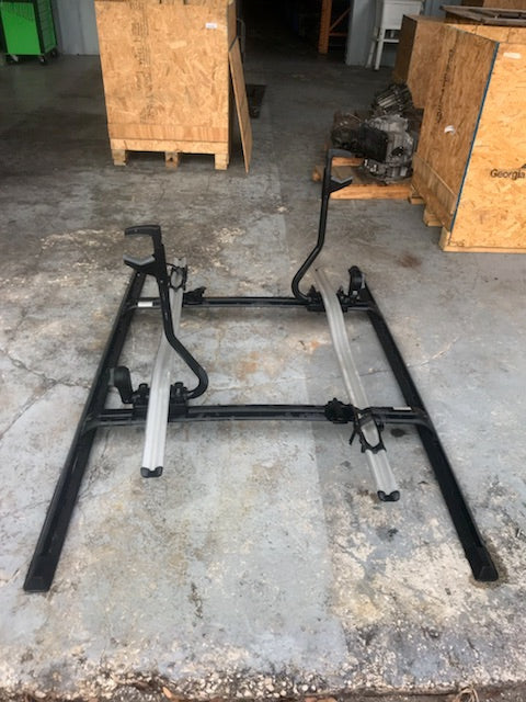 Factory Range Rover parts roof rack frame in black metal with silver rails on concrete floor