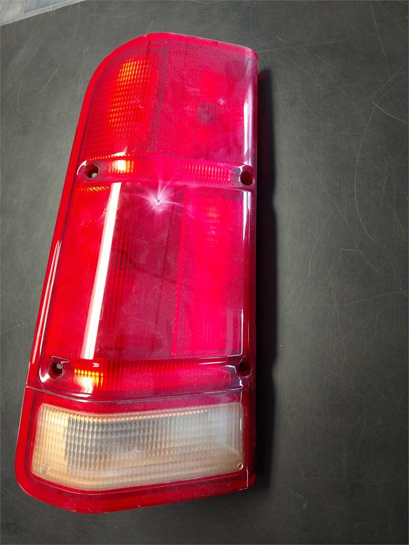 Discovery Parts red and clear tail light for vehicle replacement on black background
