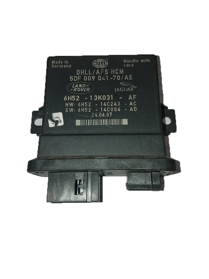 Black Land Rover LR2 electronic control module part with connector ports and label