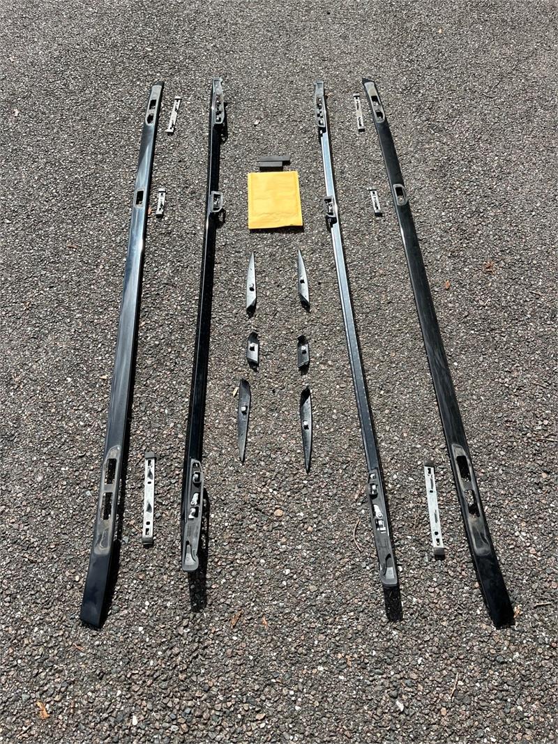 Range Rover Factory Roof Rack black roof rails crossbars and mounting hardware laid out on asphalt