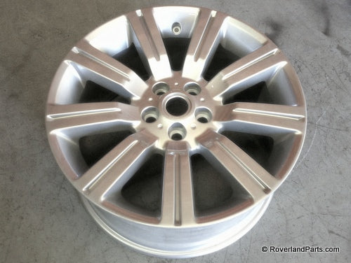 Silver alloy wheel rim for Range Rover with multi-spoke design and bolt holes