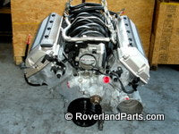 Range Rover engine part with aluminum components displayed on workshop floor