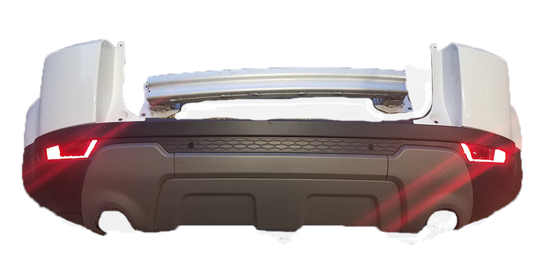 White Range Rover Evoque rear bumper with black lower trim and red tail lights illuminated