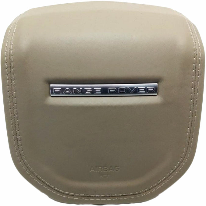 Beige Range Rover steering wheel airbag cover with Land Rover branding and stitching