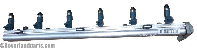 Land Rover LR2 parts Fuel Rail with multiple fuel injectors attached in silver metal finish
